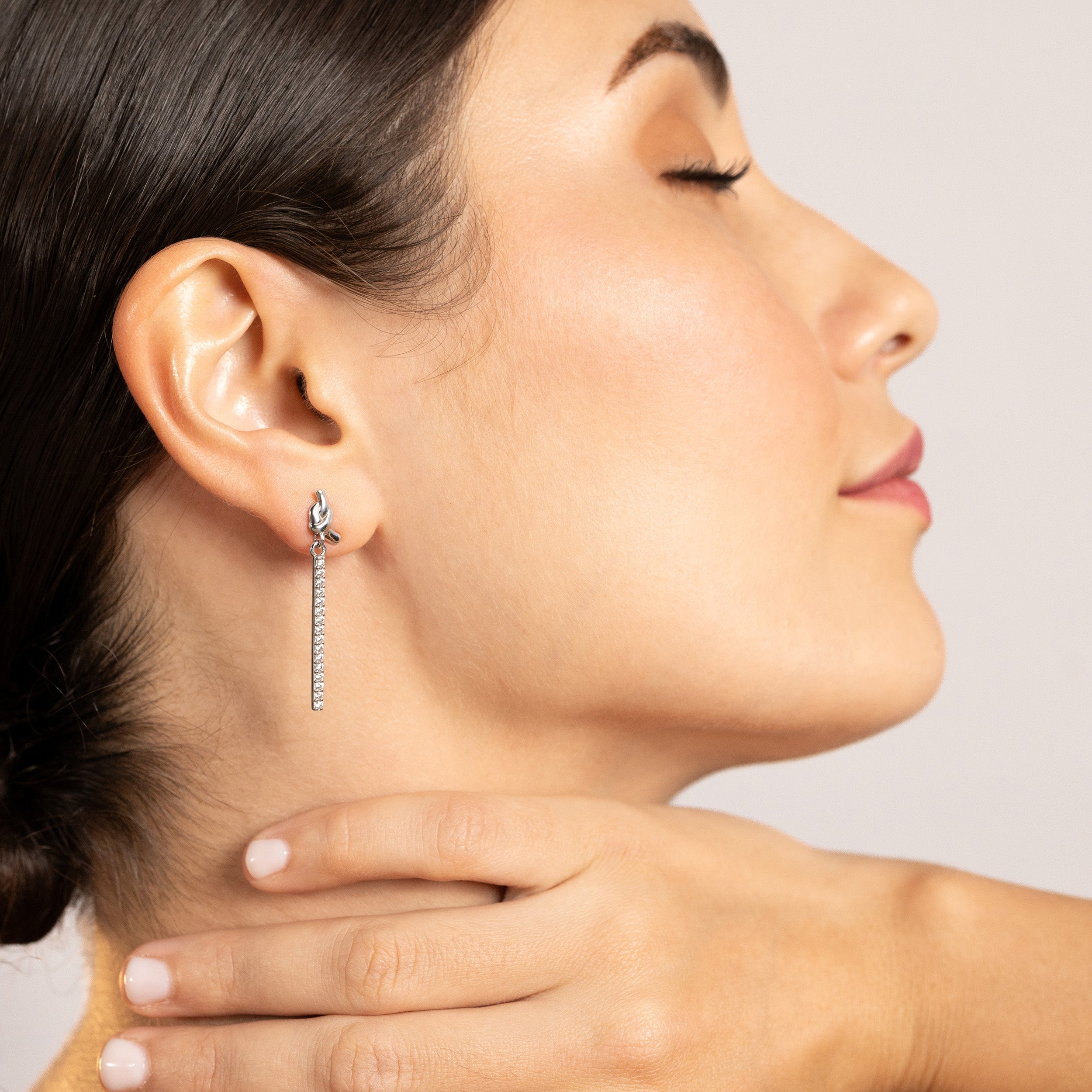 Silvershake Cubic Zirconia White Gold Plated 925 Sterling Silver Ribbon Knot and Dangle Vertical Bar Drop Stud Post Earrings April Gemstone Birthstone Jewelry for Women - Silvershake-store